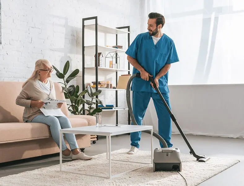 Home care professional cleaning living area