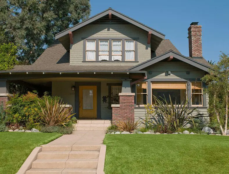 Craftsman-style house with lush garden
